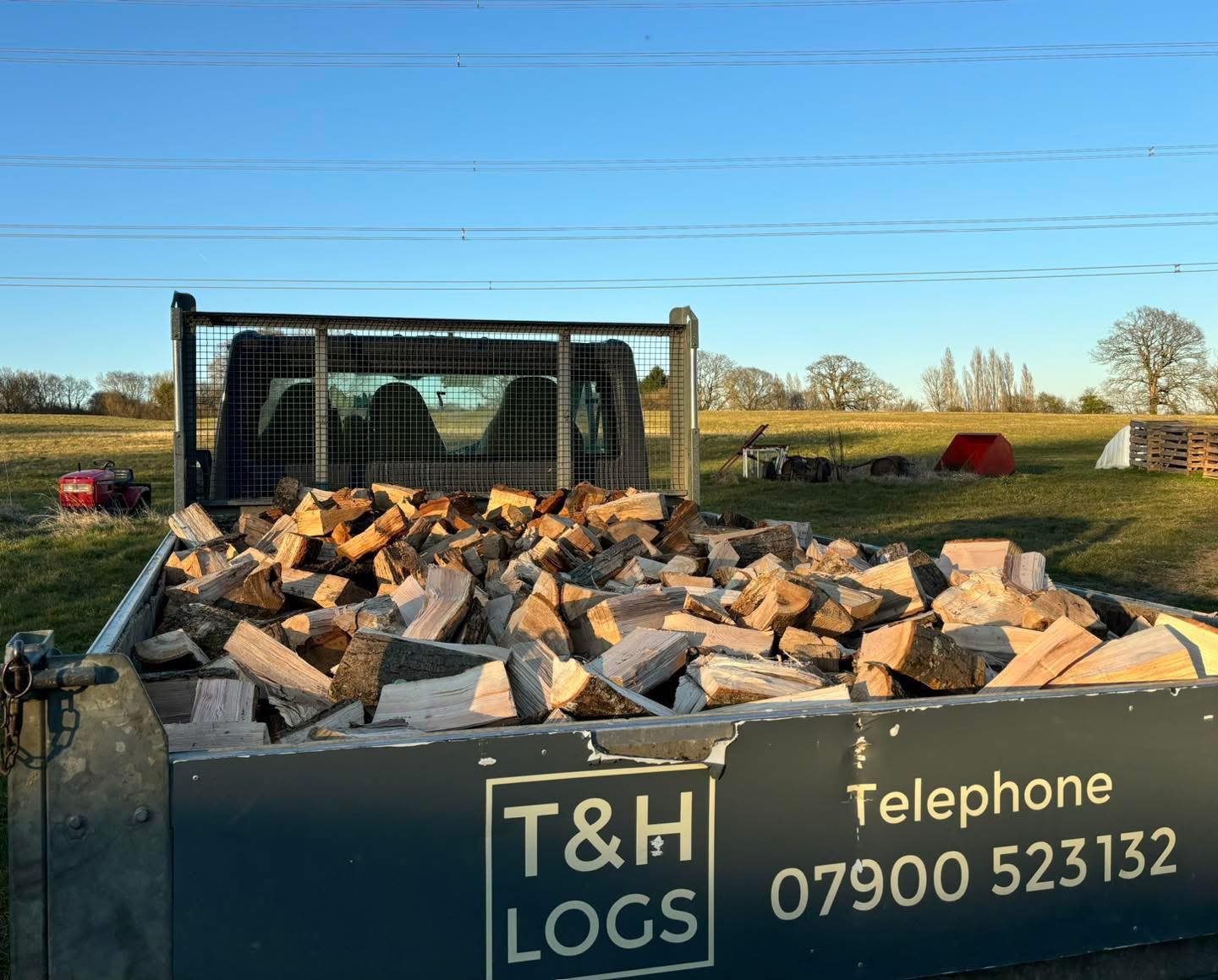 The T & H Logs branded tipper truck loaded with split seasoned hardwood